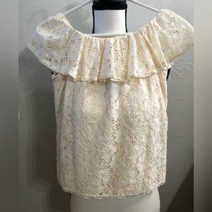 Cream colored lace blouse.